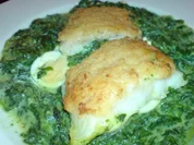 Pangasiusfilet mit Parmesankruste auf einem Spinatbett - Rezept