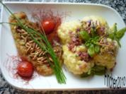Pinienkern - Schnitzel an überbackenem Blumenkohl mit Schinkenwürfeln - Rezept