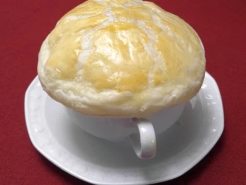 Klare Zwiebelsuppe mit Blätterteighaube - Rezept