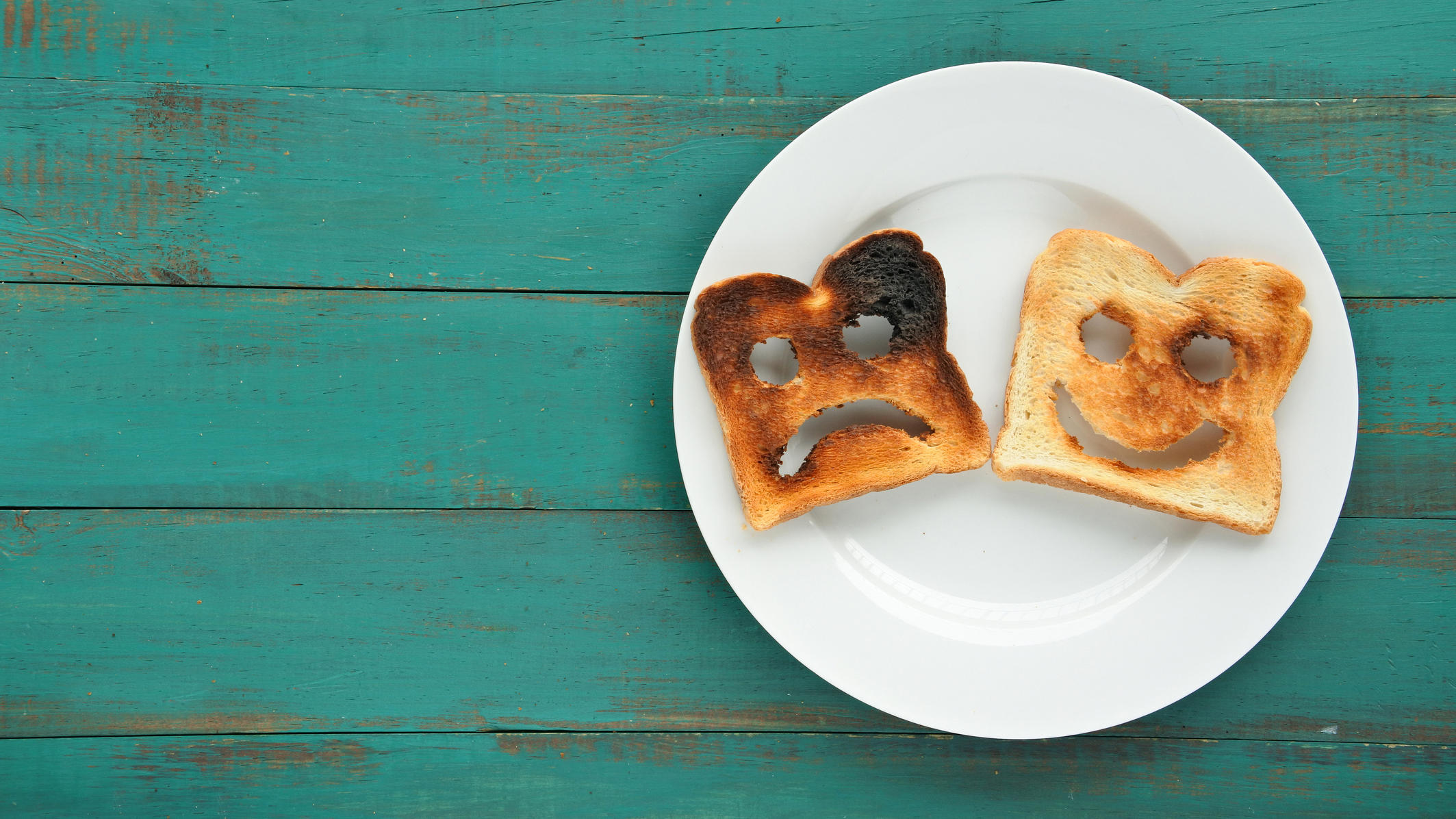 Bei 8 Toasts gibt's Mineralöl zum Frühstück Toastbrote mit lachendem und traurigem Gesicht.