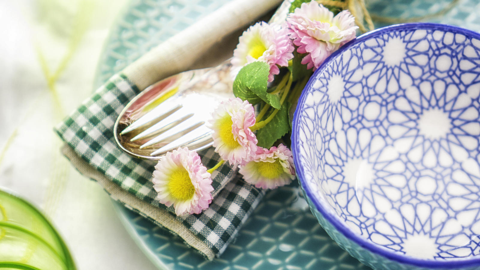 Fertig vom Discounter oder frisch gekocht: Welches Ostermenü schmeckt besser? Colorful decorated Easter Place Setting with Easter Eggs, flowers on the table